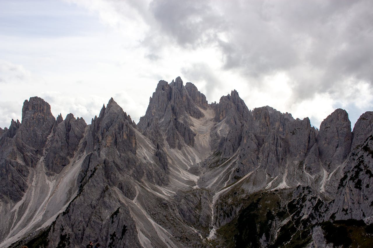 Stunning jagged peaks of the Dolomites under a cloudy sky in Bolzano, Italy.